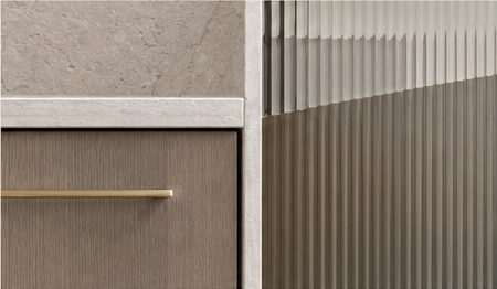 Limestone slab, rift-oak drawer with a brass pull, and fluted glass meeting in one interior detail